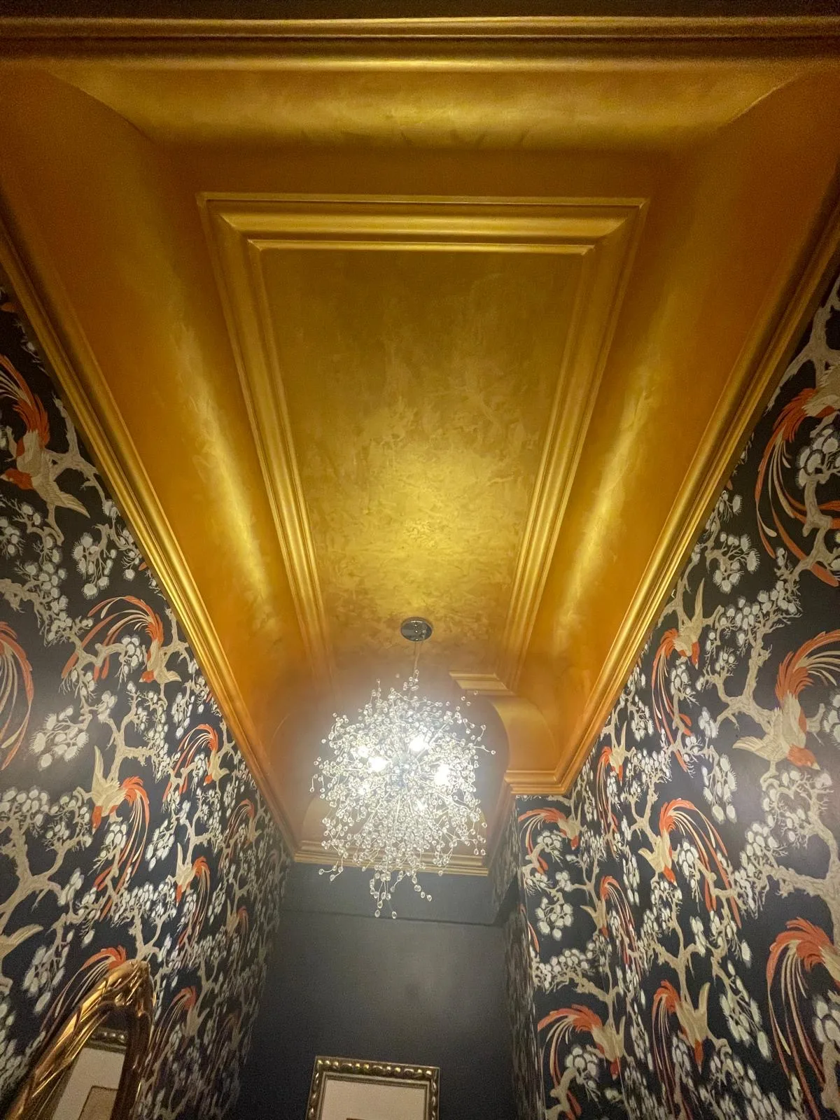 Powder room wallpaper with gold detail